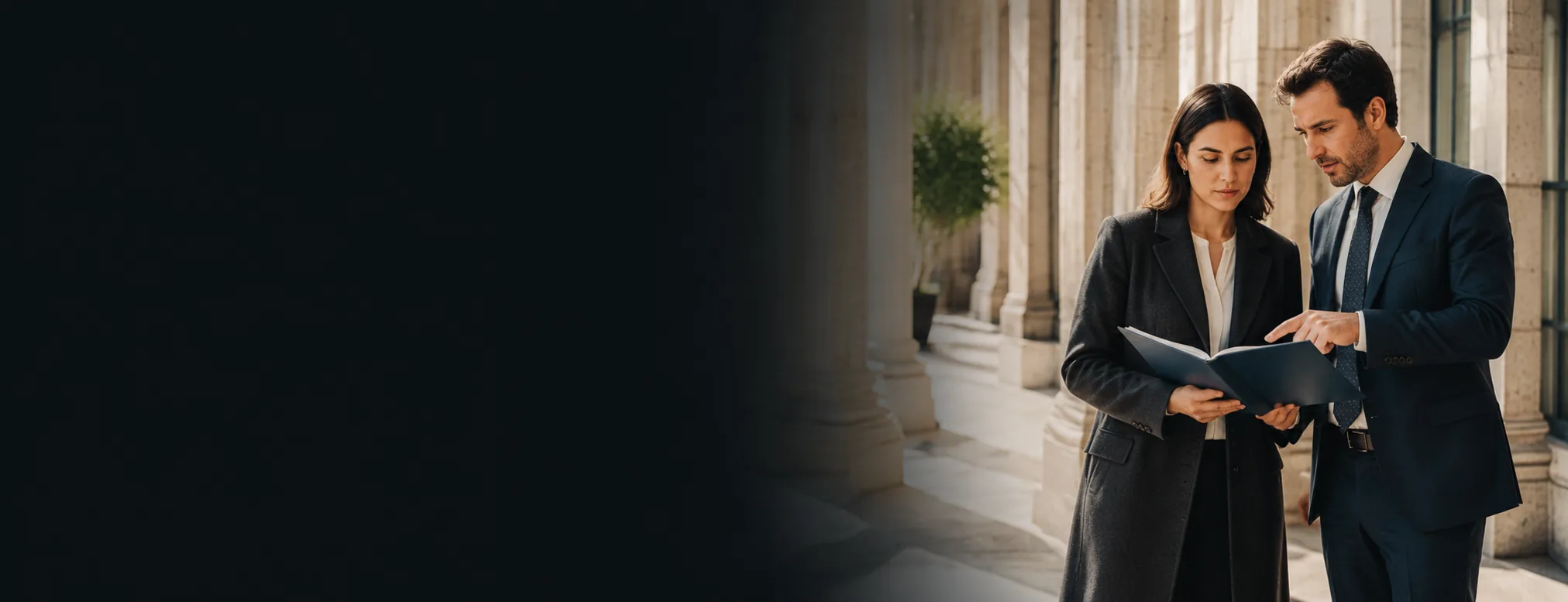 A solicitor and client reviewing a case file outside a court colonnade